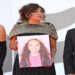From left, Saja Kilani, Kaouther Ben Hania and Motaz Malhees display a picture of Hind Rajab as they arrive for the premiere of The Voice of Hind Rajab. Photograph: Ettore Ferrari/EPA