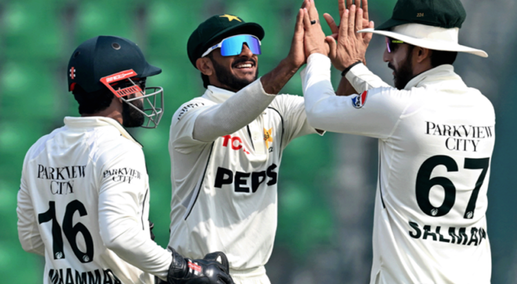 Pakistan's players celebrate after the dismissal of South Africa's Senuran Muthusamy during the third day of the first Test cricket match between Pakistan and South Africa at the Gaddafi Stadium in Lahore on October 14, 2025. (AFP)