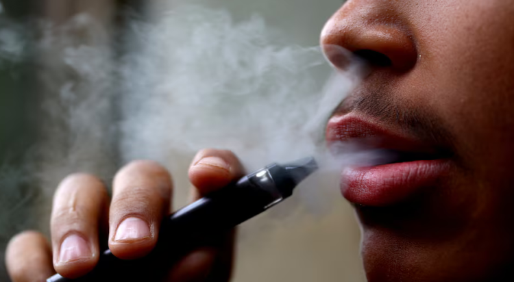 A man smokes a disposable vape, Newcastle-under-Lyme, Britain, September 14, 2023. REUTERS/Carl Recine