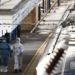 Forensic officers walk next to the London North Eastern Railway (LNER) train where a series of stabbings took place, at a platform at Huntingdon Station, near Cambridge, Britain, November 2, 2025. REUTERS/Jack Taylor