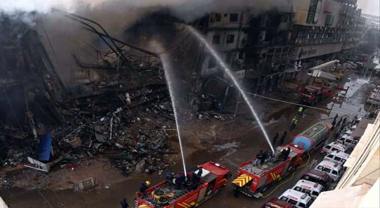 Firefighters and rescue workers make efforts to douse a fire at the Gul Plaza shopping mall on Karachi’s MA Jinnah Road on Jan 18, 2026. — Shakil Adil/White Star via Dawn.com