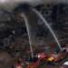 Firefighters and rescue workers make efforts to douse a fire at the Gul Plaza shopping mall on Karachi’s MA Jinnah Road on Jan 18, 2026. — Shakil Adil/White Star via Dawn.com
