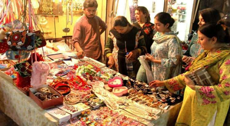 This undated image shows women busy in Eid shopping a local market. (APP)