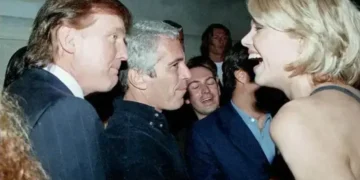This undated photo from the personal collection of Jeffrey Epstein provided by the Democrats on the House Oversight Committee on December 12, 2025, shows US President Donald Trump (L), flanked by Epstein (C), talking to an unknown woman. — AFP/File
