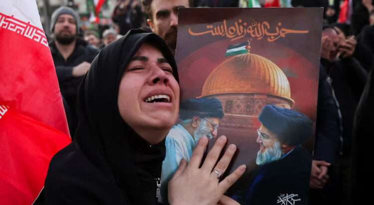 A woman reacts as people gather at the Enghelab Square, after Iran's Supreme Leader Ayatollah Ali Khamenei was killed in Israeli and U.S. strikes on Saturday, in Tehran, Iran, March 1, 2026. Majid Asgaripour/WANA (West Asia News Agency) via REUTERS