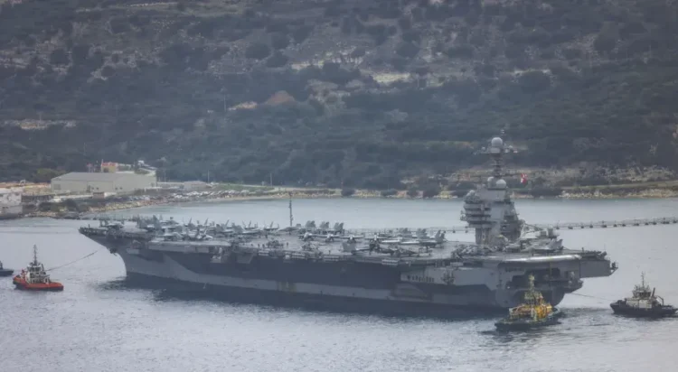 A view of the US aircraft carrier USS Gerald R. Ford at a US Navy base in Souda Bay, Crete, where it is set to undergo repairs on March 23, 2026. [Stefanos Rapanis – Anadolu Agency]