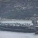 A view of the US aircraft carrier USS Gerald R. Ford at a US Navy base in Souda Bay, Crete, where it is set to undergo repairs on March 23, 2026. [Stefanos Rapanis – Anadolu Agency]