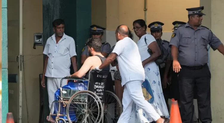 An injured person moves on a wheelchair at the National Hospital Galle where he will receive treatment after a submarine attack on an Iranian ship off Sri Lanka, in Galle, Sri Lanka, March 4, 2026. REUTERS/Thilina Kaluthotage