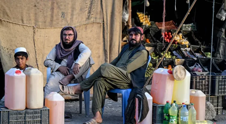 Pakistani men selling petrol wait for customers at their stall in the Pakistan–Iran border town of Taftan, Balochistan province on March 4, 2026. (AFP)