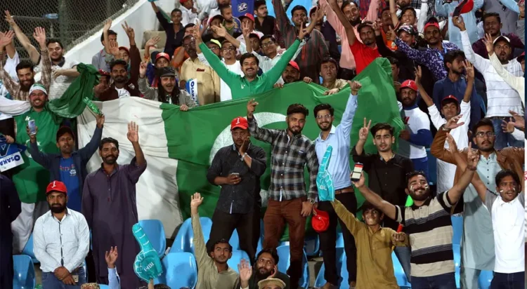 This undated photo shows spectators cheering and waving the Pakistan flag proudly. — AP