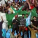 This undated photo shows spectators cheering and waving the Pakistan flag proudly. — AP