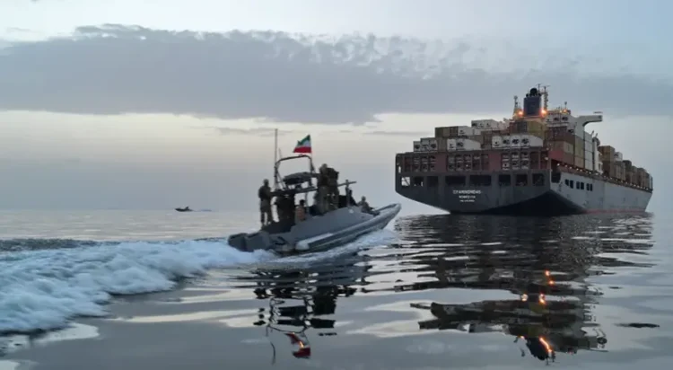 An IRGC boat approaches a cargo vessel in the Strait of Hormuz [File: Tasnim via AFP]