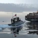 An IRGC boat approaches a cargo vessel in the Strait of Hormuz [File: Tasnim via AFP]